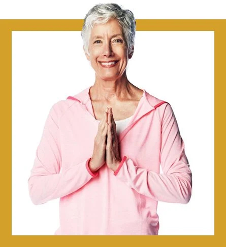 an elderly woman with her hands in a praying position or yoga