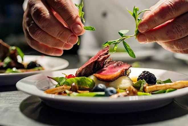 a chef plating food