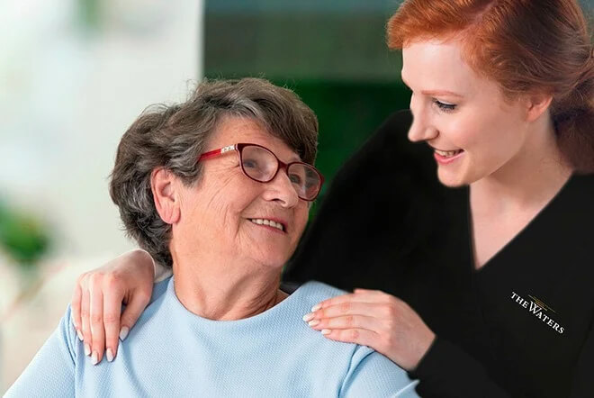 a younger woman embracing an elderly woman