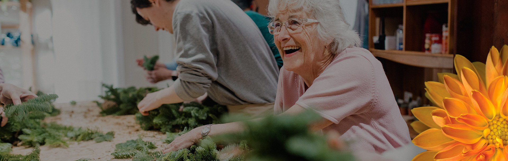 an elderly woman making christmas decorations