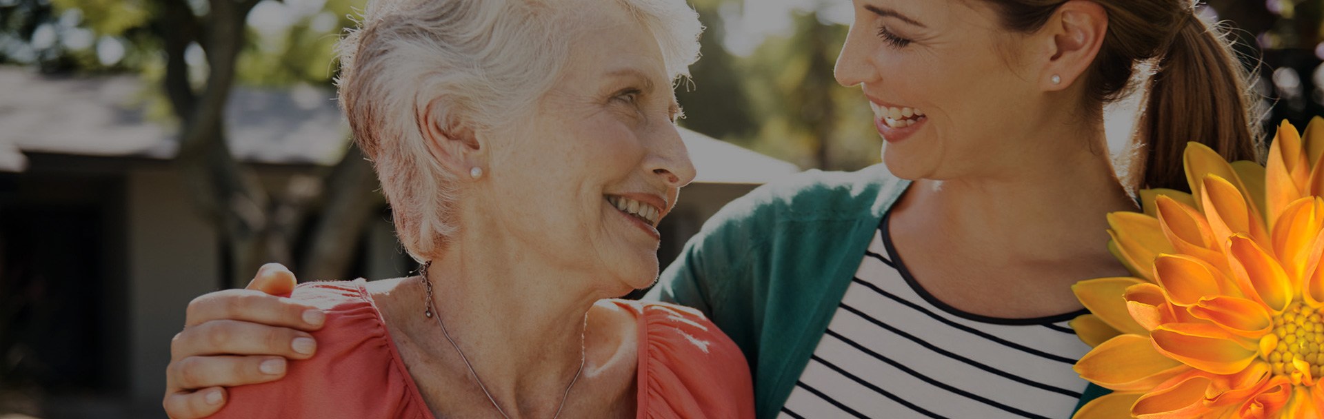 a younger woman embracing an elderly woman