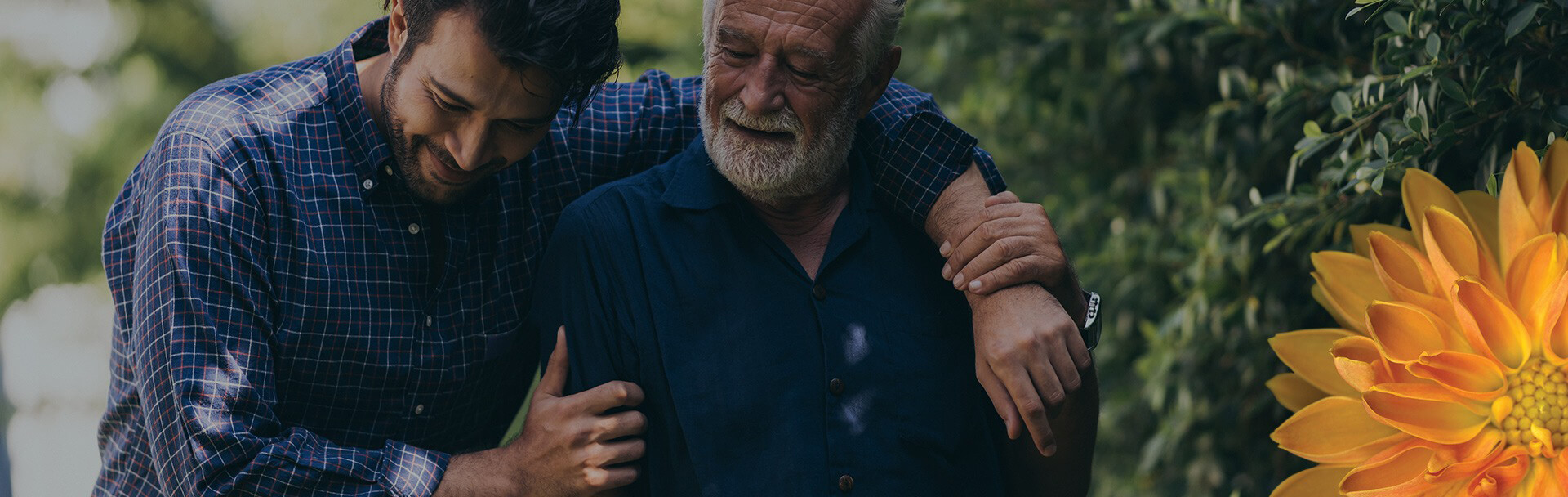 a man and an elderly man embracing