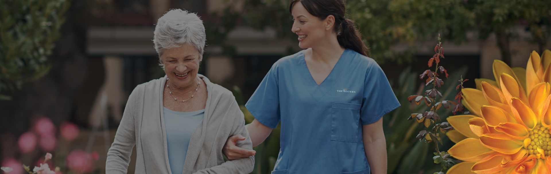 an elderly woman and a young woman walking outside