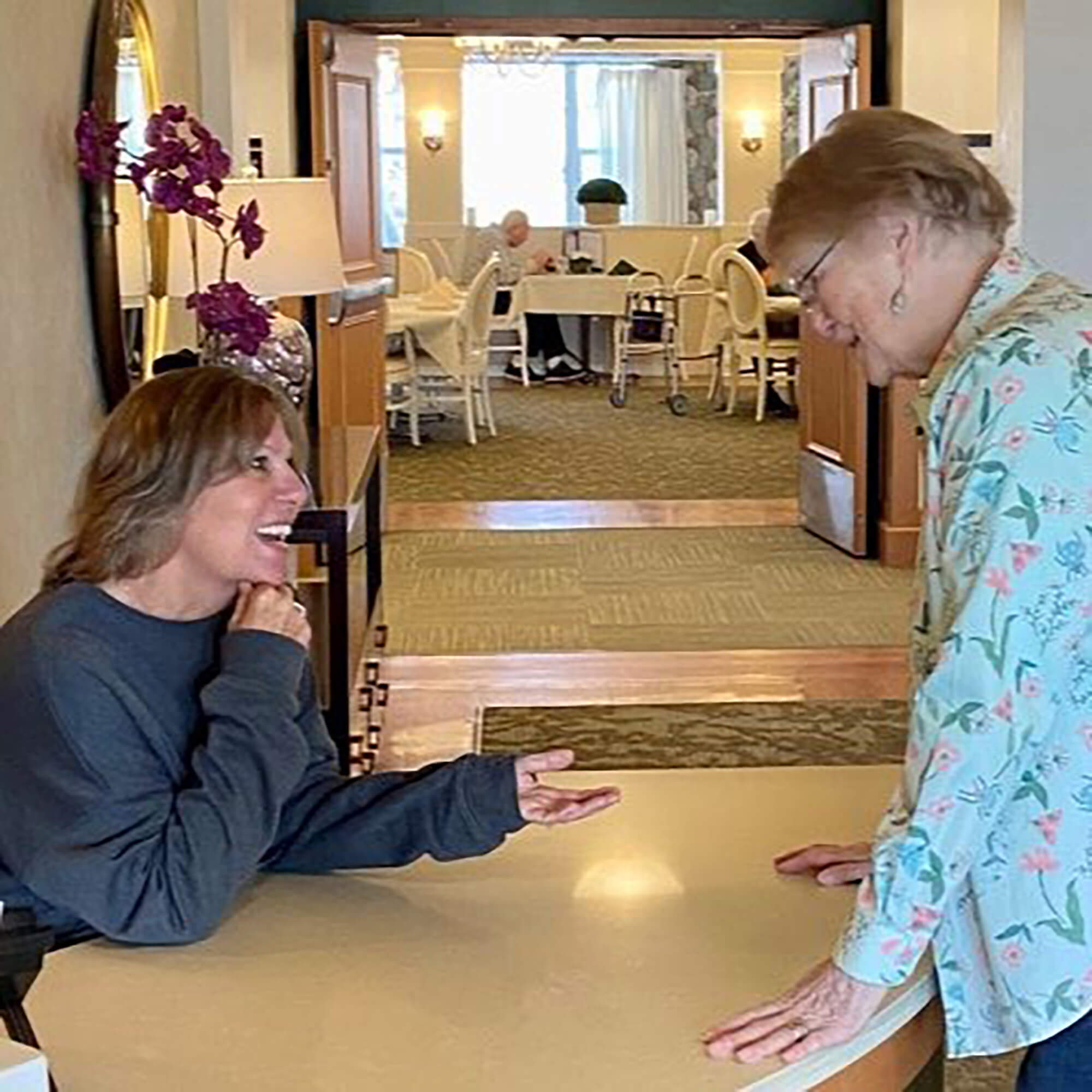a resident speaking with a team member at the desk