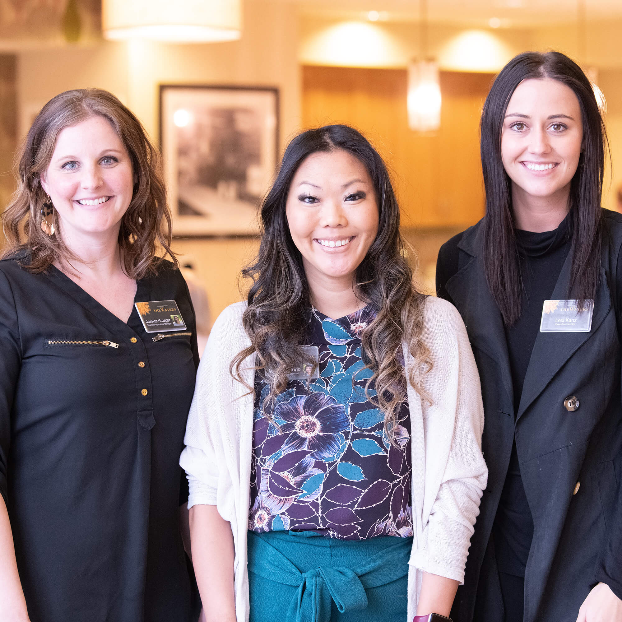 three female team members smiling