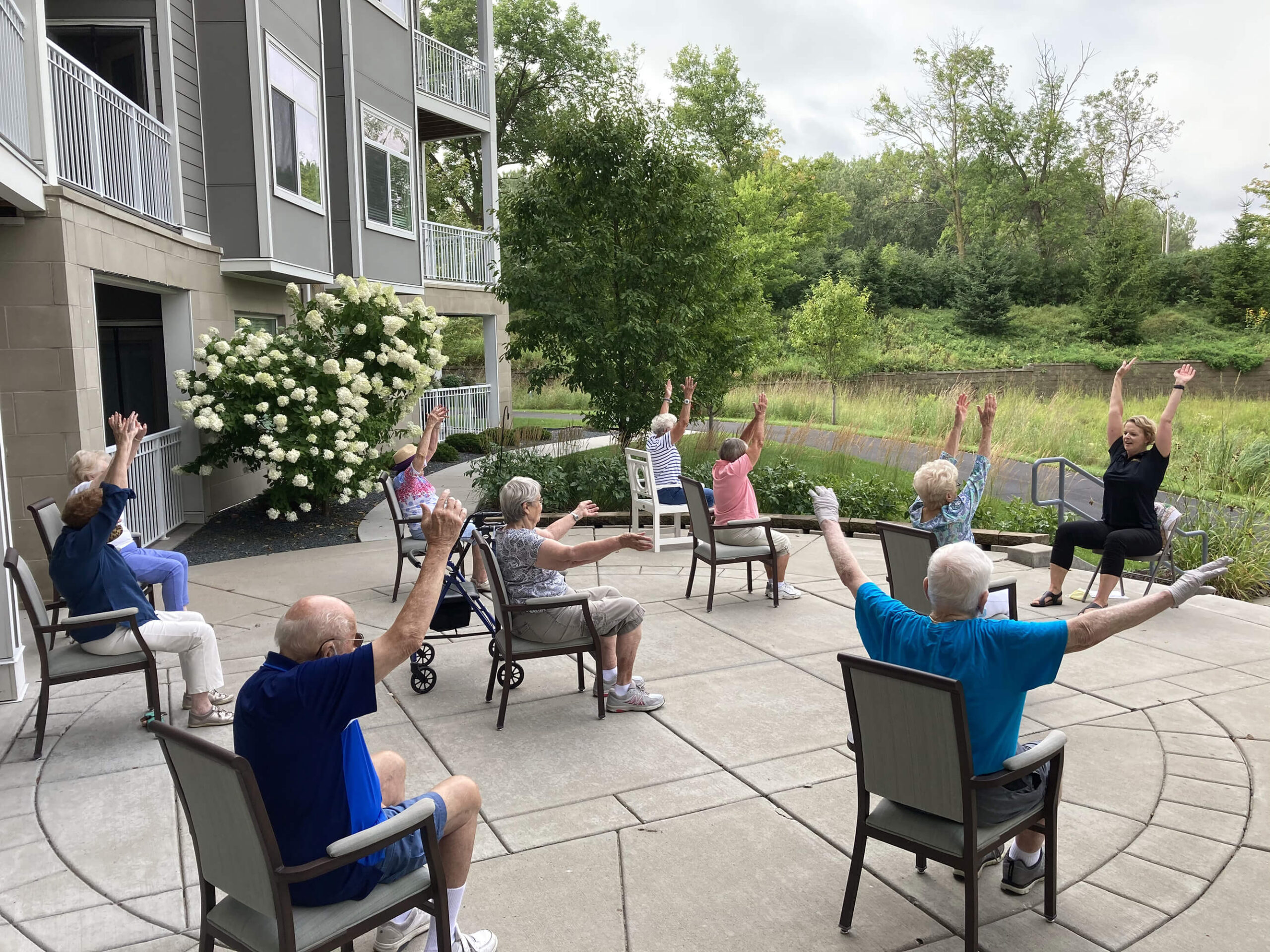 Seniors engaging in outdoor chair exercises with enthusiasm in Edina, Minnesota community.
