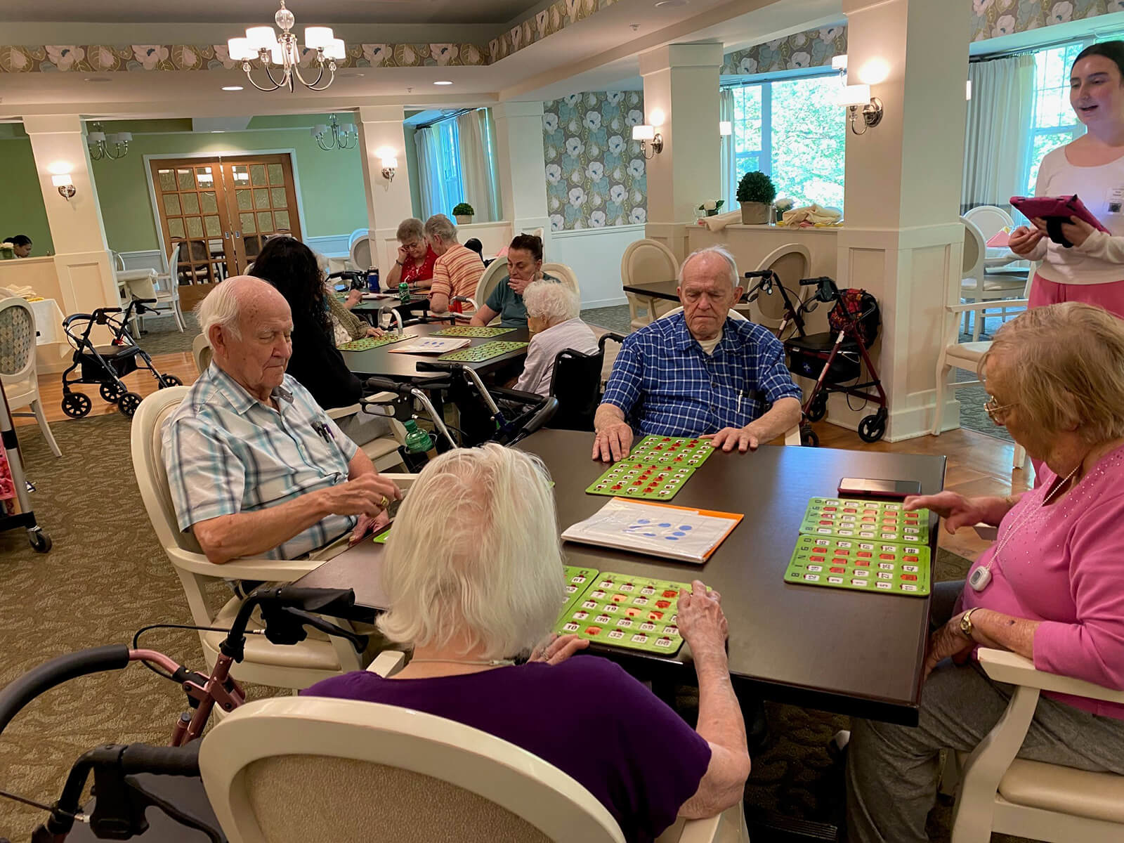 A charming scene at The Waters of Oakdale with residents donning creative hats, enhancing the vibrant and playful community life.