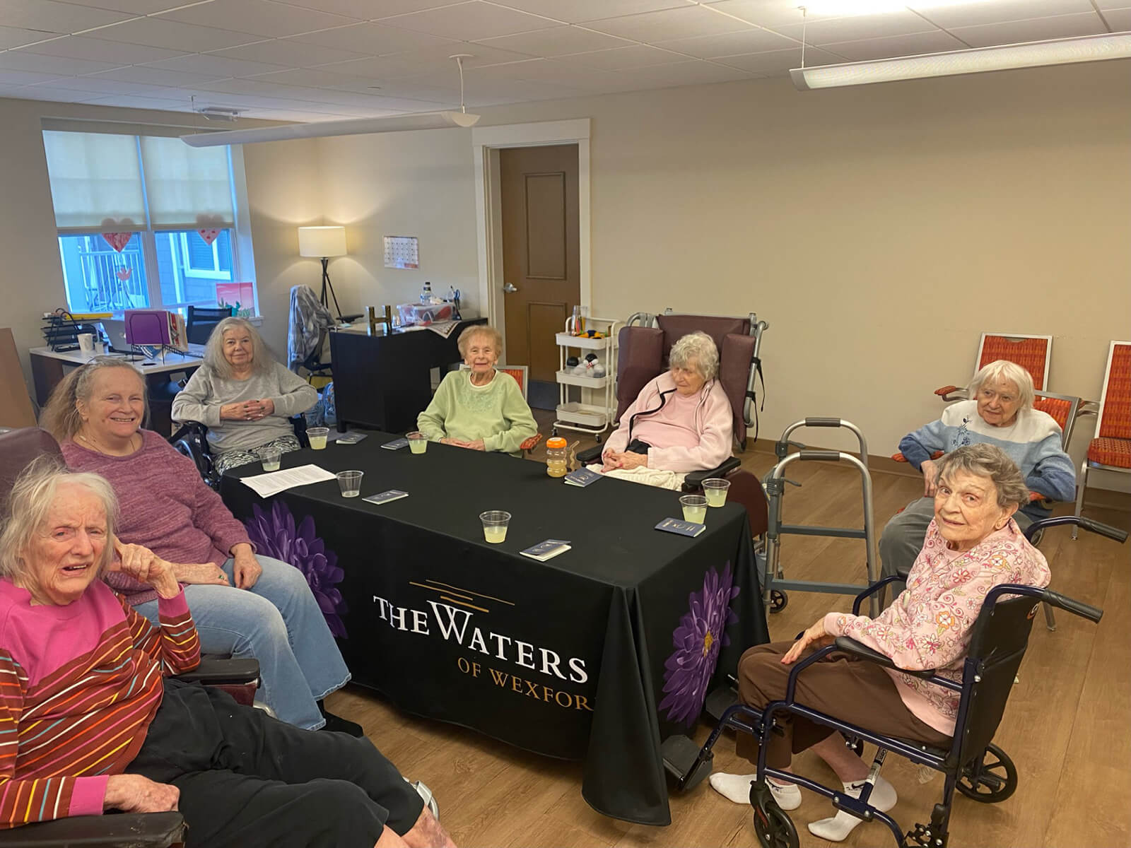 A group of seniors enjoying a social card game at The Waters of Wexford, fostering friendship and leisure.