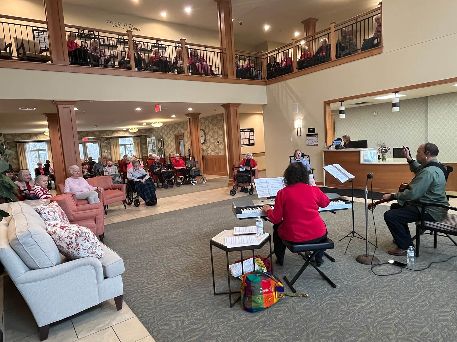 Residents enjoy a live choir performance in the living room of The Waters of Plymouth.