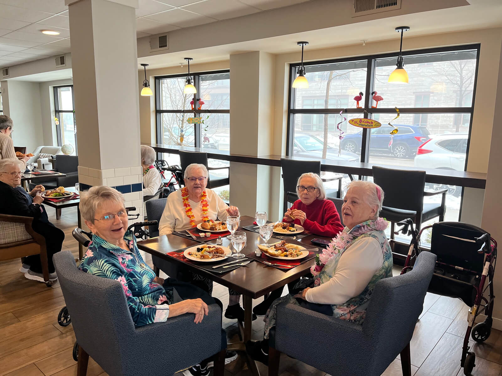 Elderly residents enjoying a meal together in The Waters of Oak Creek dining area.