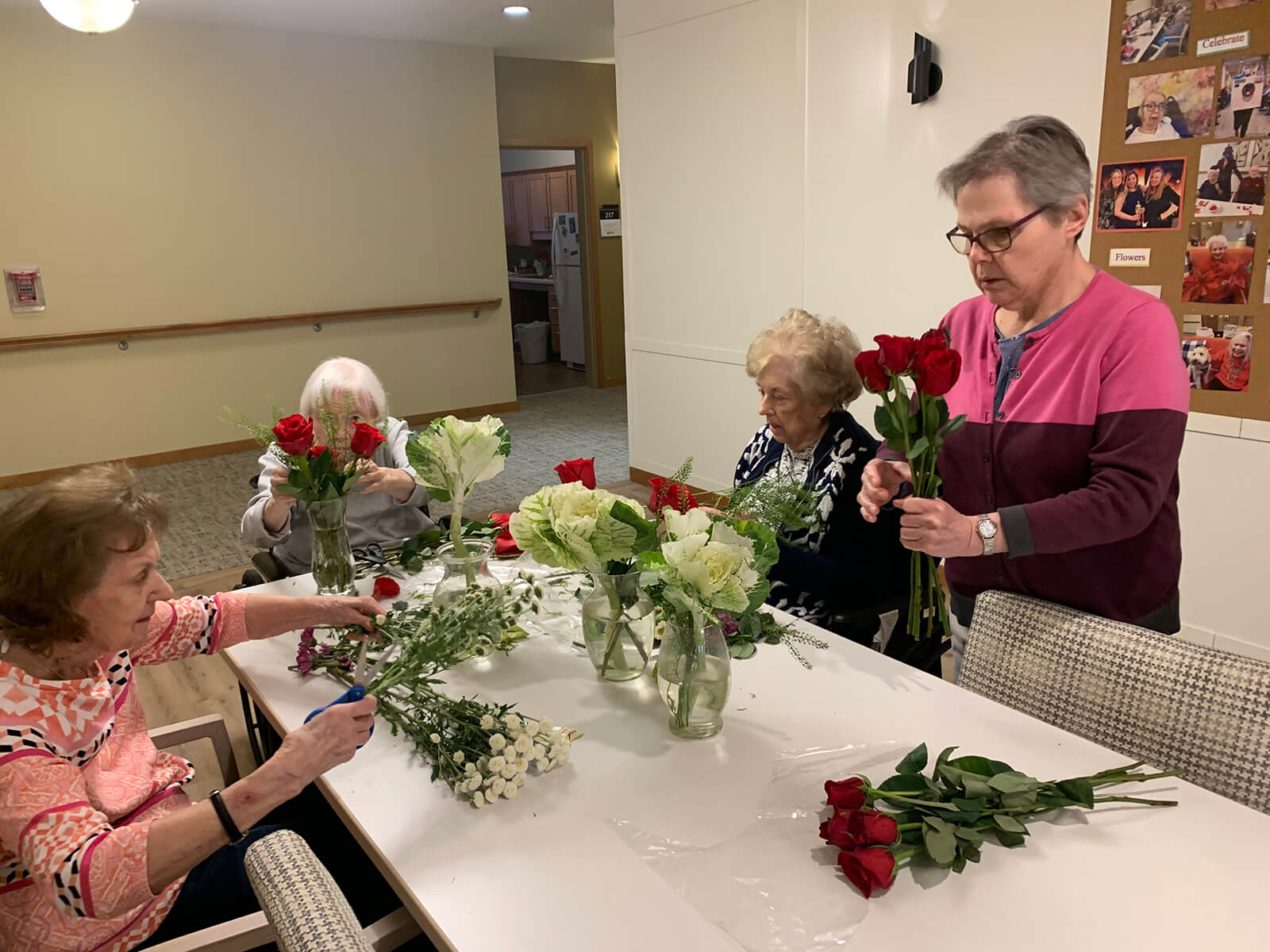 Senior women engaging in a flower arrangement workshop at The Waters of Plymouth.