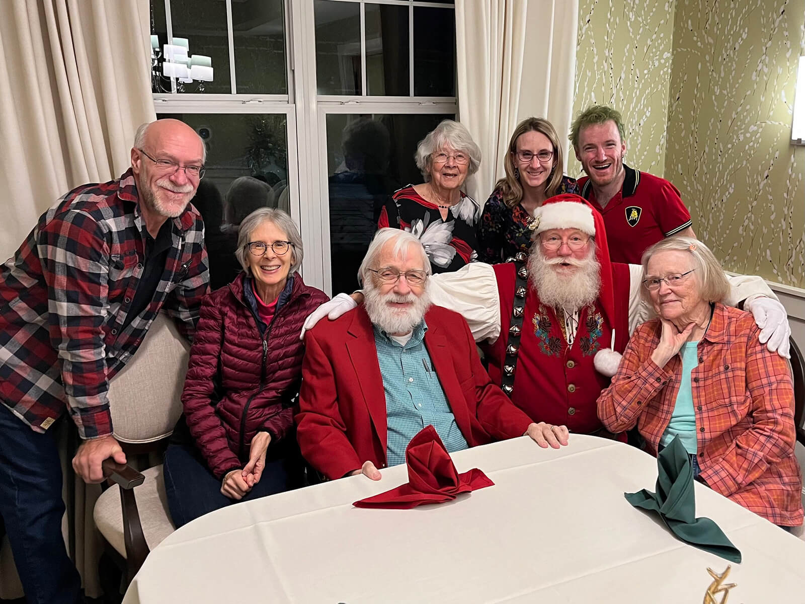 Residents of The Waters of Oakdale enjoying a festive holiday celebration with a Santa Claus impersonator, embodying the community's holiday spirit.