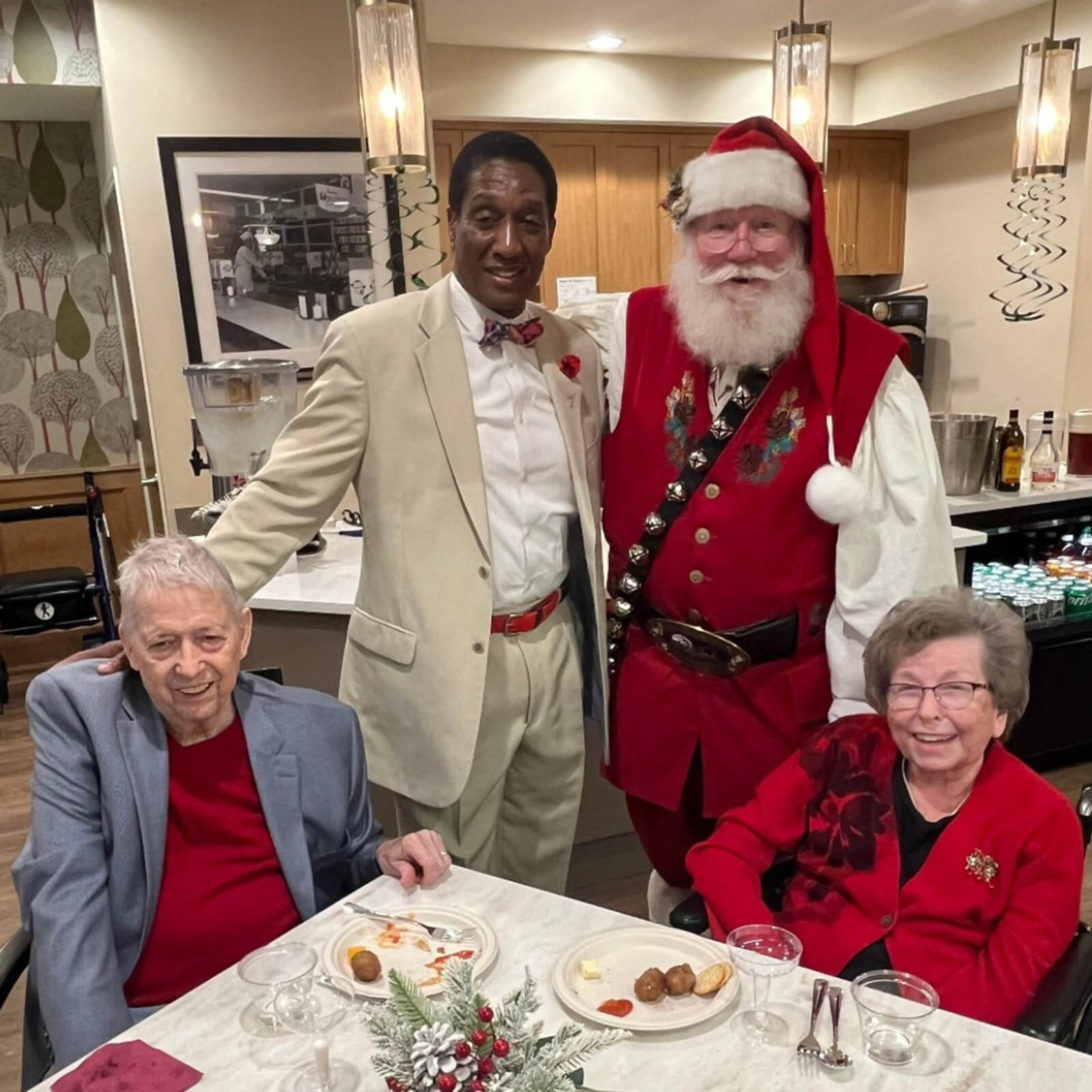 Seniors at The Waters on 50th in Minneapolis having a delightful time with Santa during a holiday party.
