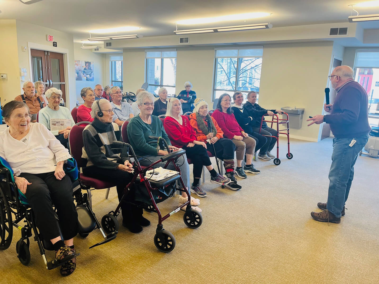 Senior residents of Highland Park enjoying an interactive lecture at a community gathering.