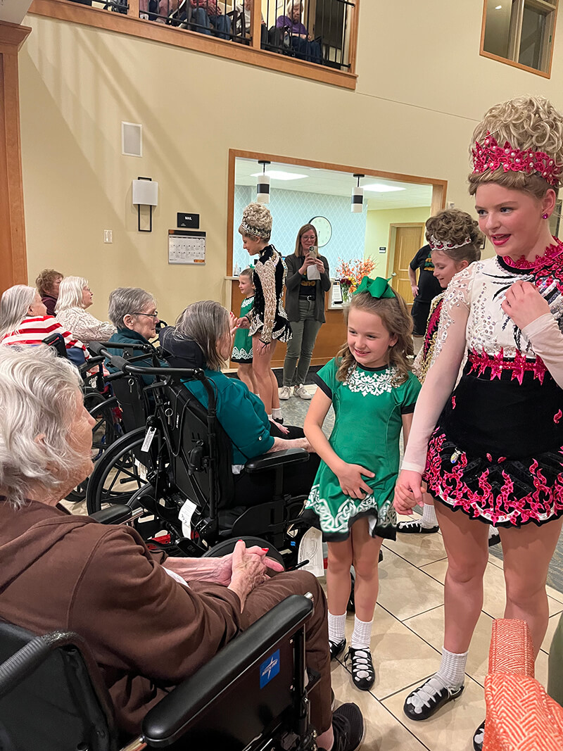 Seniors at The Waters of Plymouth watching an Irish dance performance.