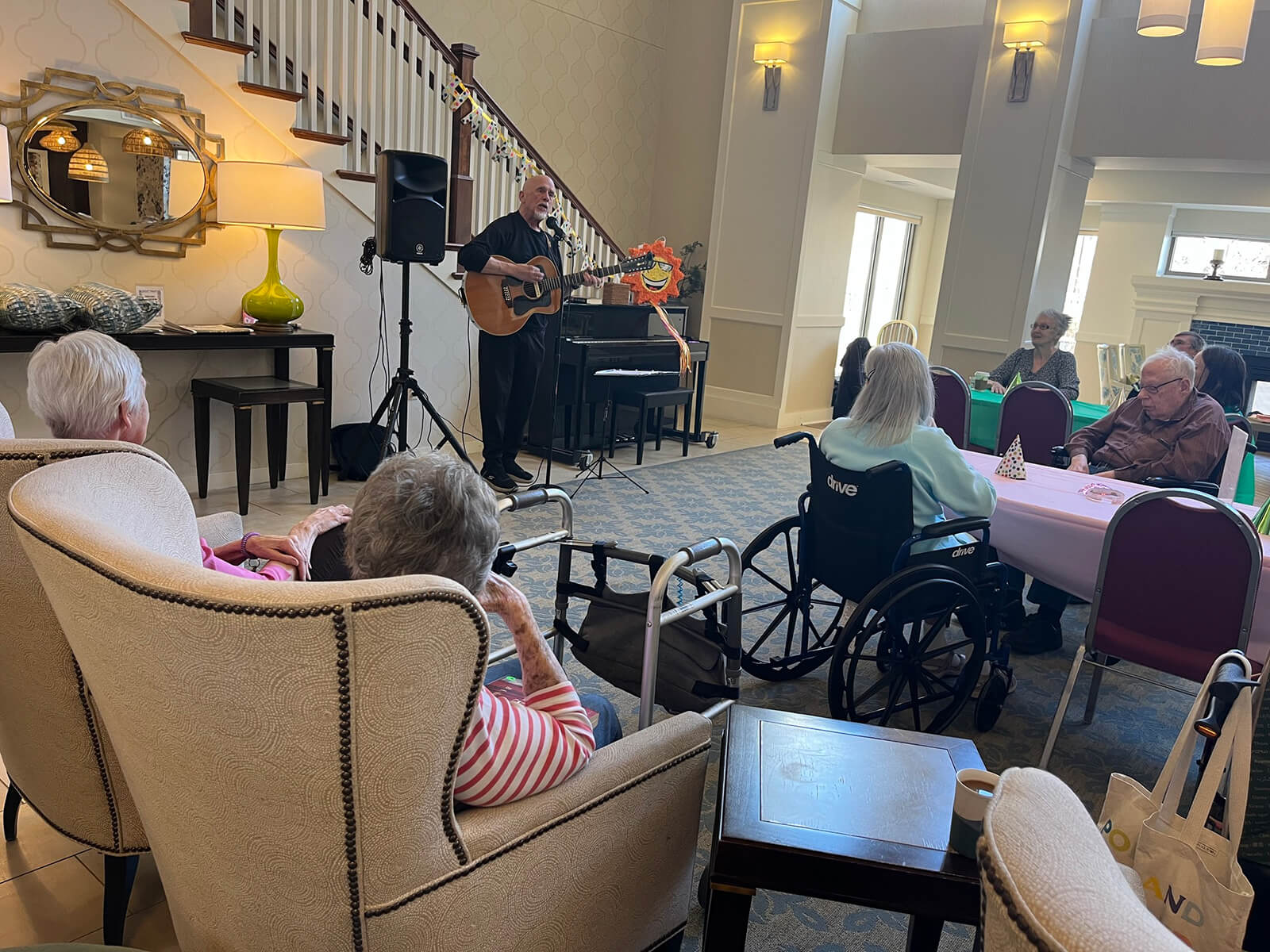 Residents listening to live guitar music at The Waters of Highland Park.