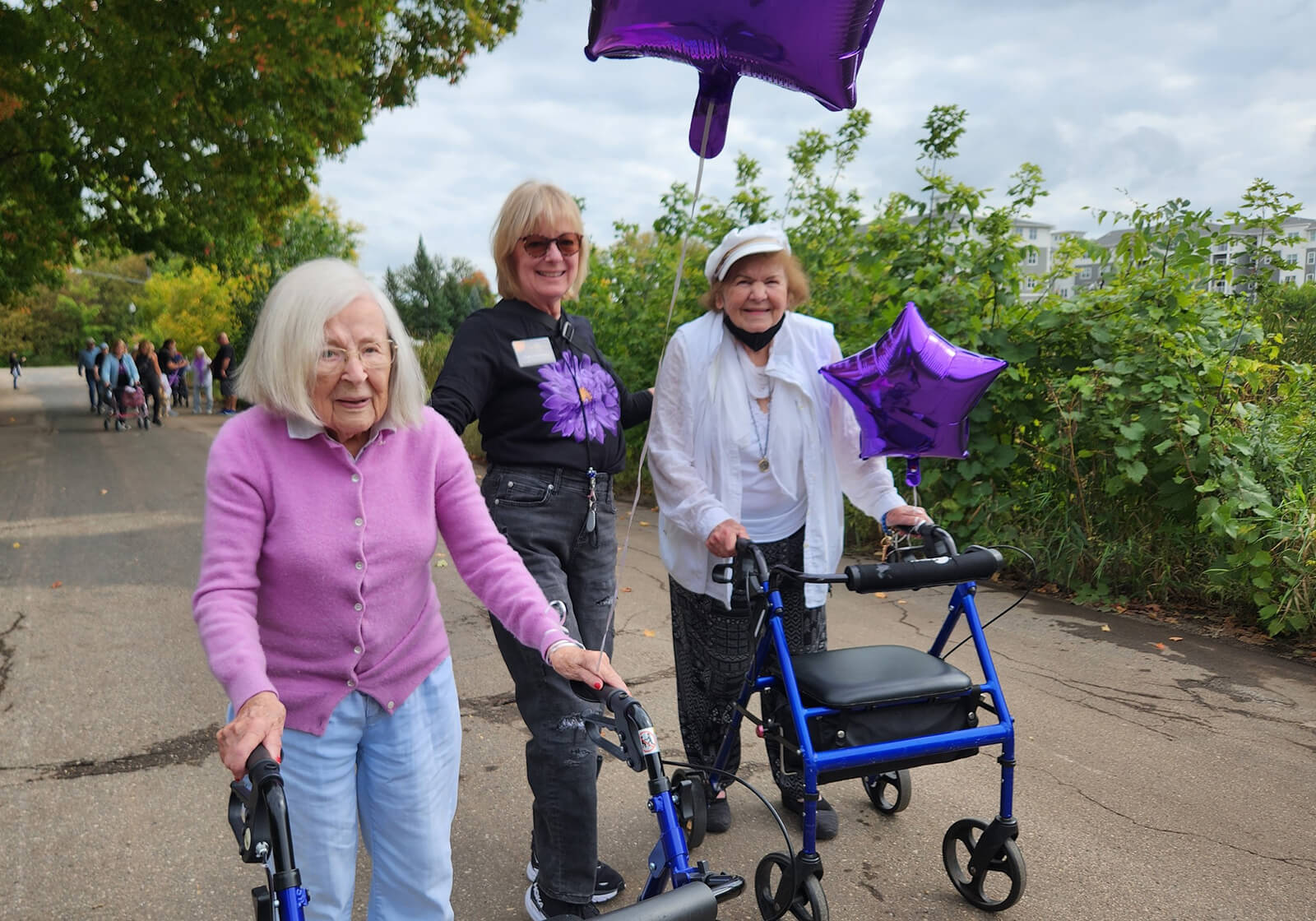 Residents and staff from The Waters of Excelsior participating in a memory walk, showing support for Alzheimer's awareness and research.