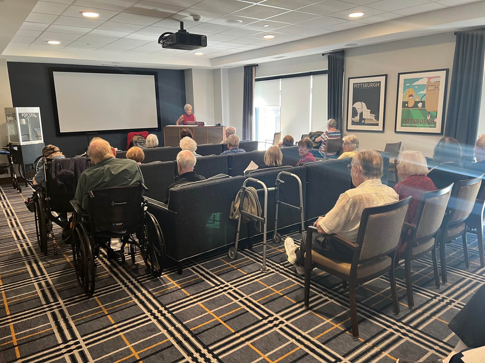 Residents attending an educational movie presentation at The Waters of McMurray.