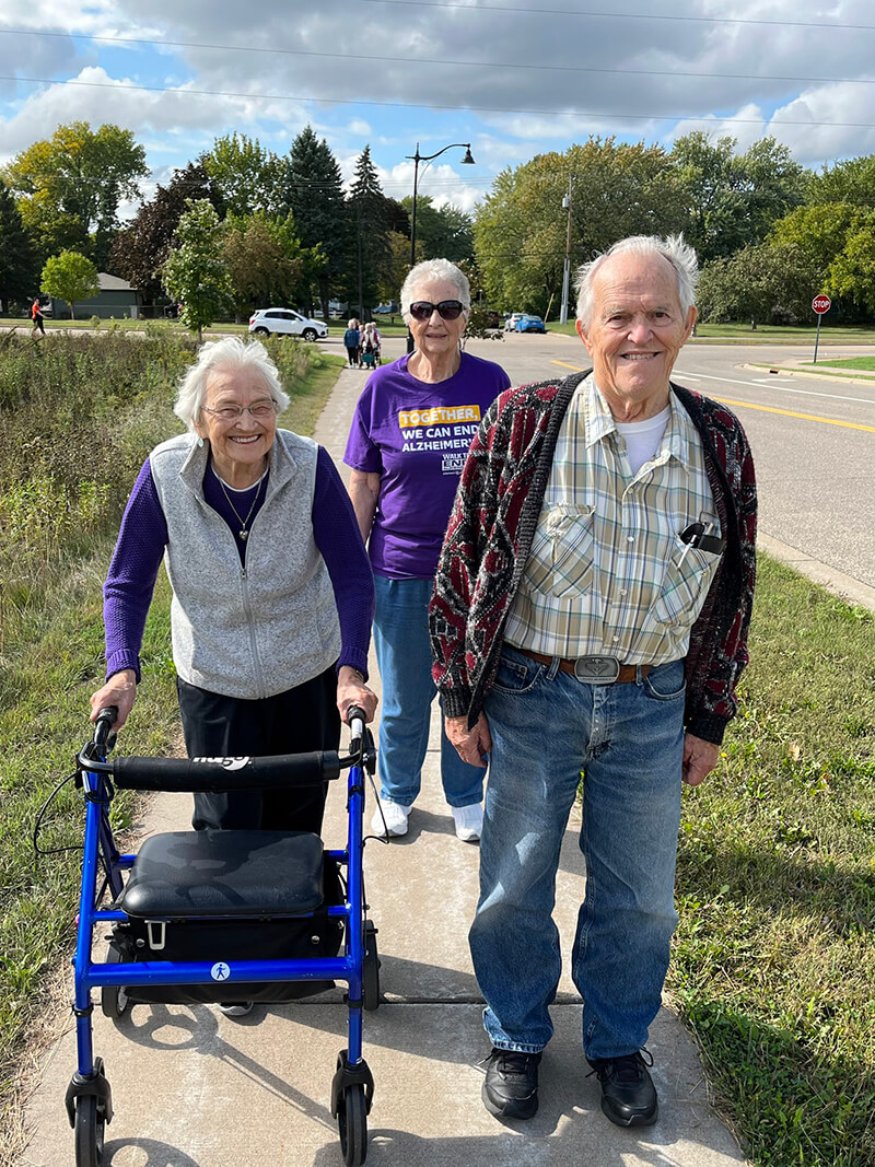 Seniors from The Waters of Oakdale participating in an outdoor walk to support Alzheimer's research, demonstrating community involvement and active living.