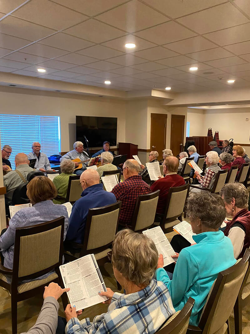 Seniors at The Waters on Mayowood gathered for a choir session, highlighting the community's commitment to musical enrichment.
