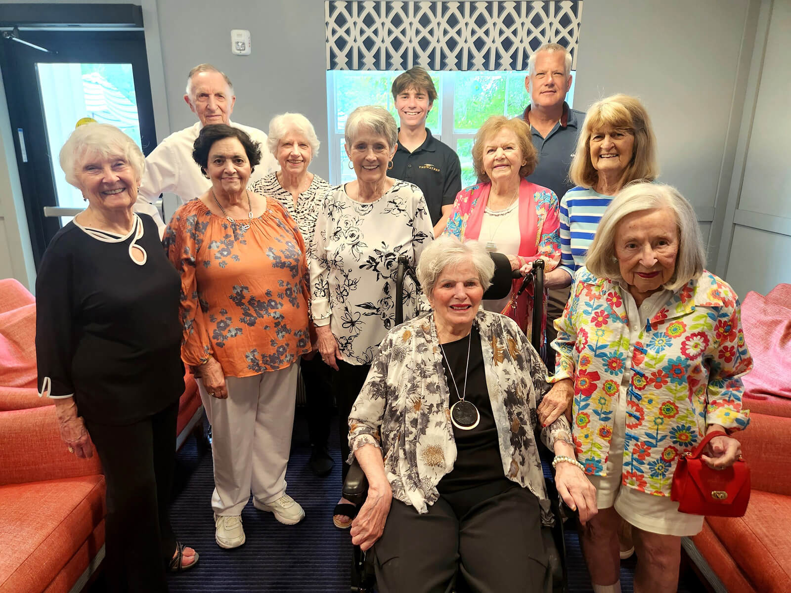 Smiling residents of The Waters of Excelsior posing for a group photo, highlighting the close-knit and friendly community atmosphere.