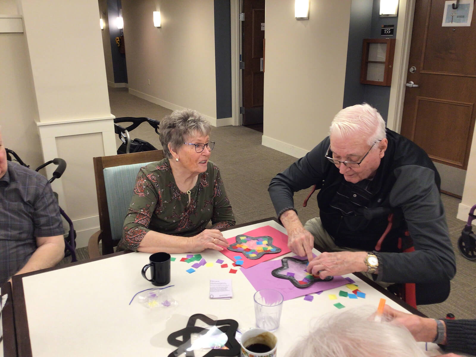 A group of seniors at The Waters on Mayowood enjoying a puzzle game, fostering cognitive engagement and social interaction.