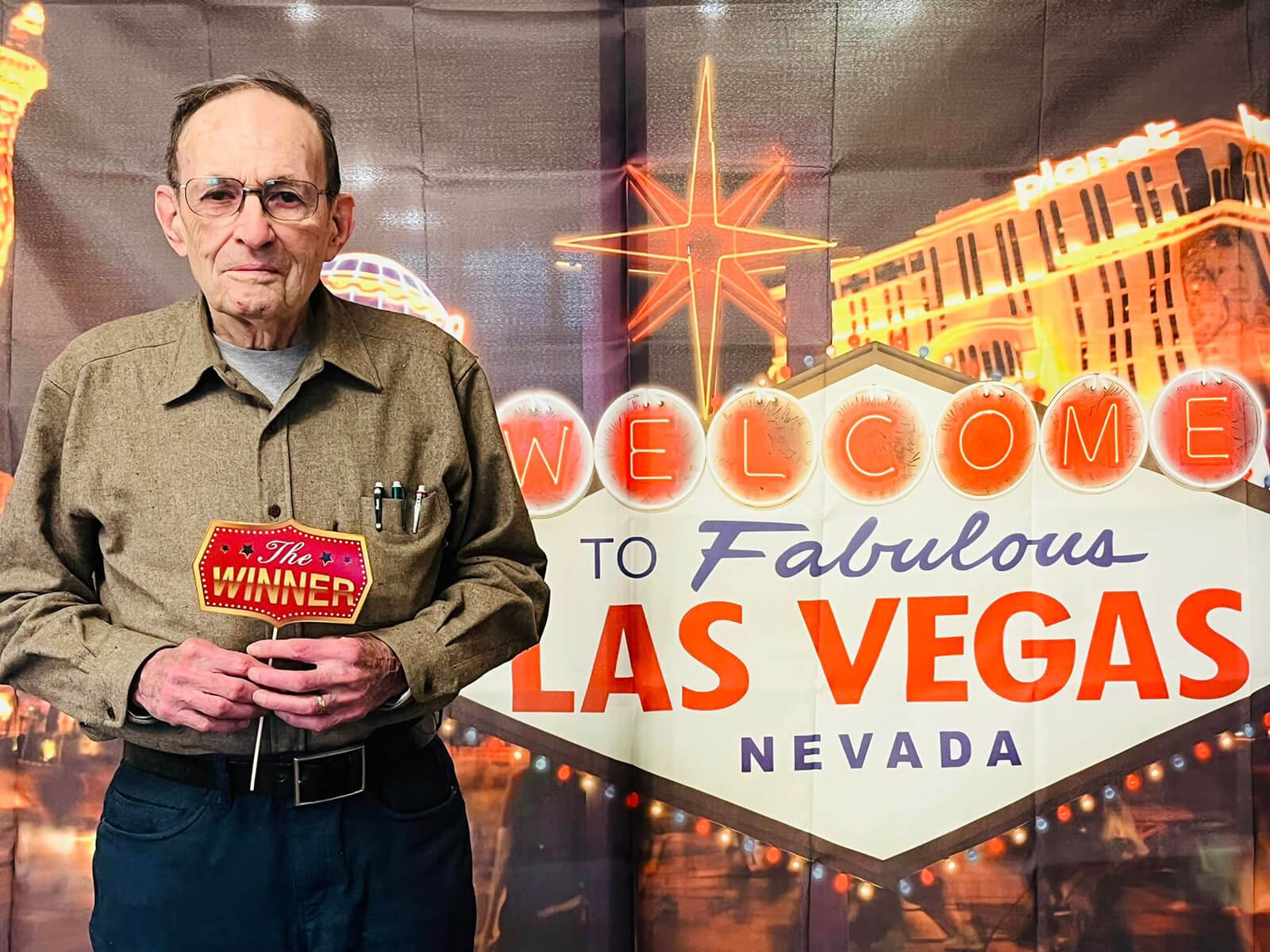 Resident at The Waters of Eden Prairie with Las Vegas-themed backdrop.