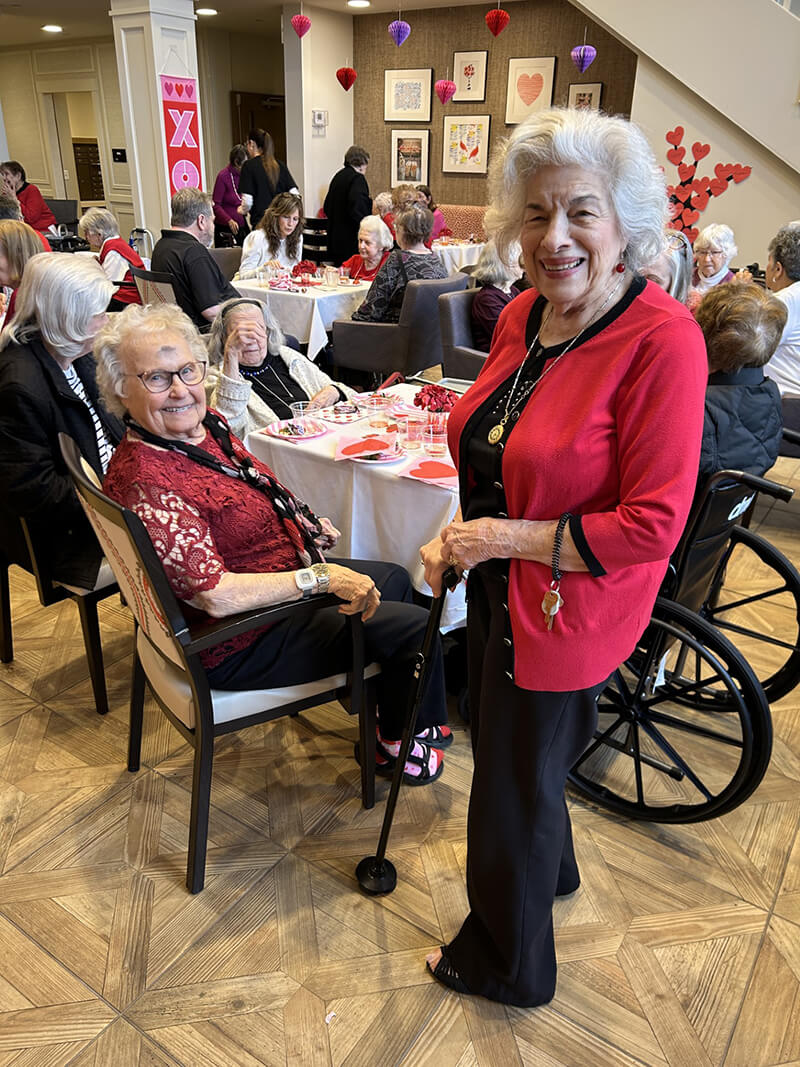 Residents of The Waters of Wexford celebrating Valentine's Day with smiles and joy, enhancing the spirit of community.