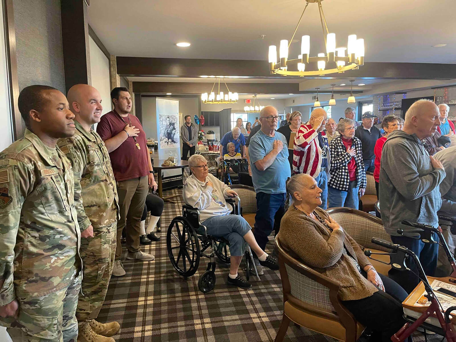 Veterans and residents at The Waters of Oak Creek during a salute to the flag.