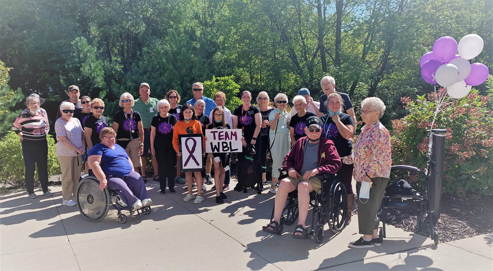 Residents of The Waters of White Bear Lake participating in a community walk for charity, showing team spirit and engagement.